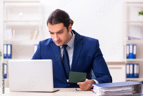 Canvastavla Young man checking passport in the office