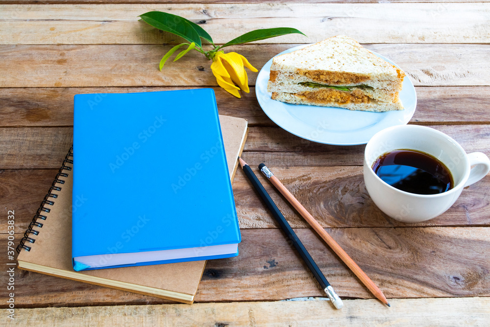 notebook planner for business work with breakfast hot coffee espresso ,sandwich arrangement flat lay style at office on background wooden notebook planner for business work with breakfast hot coffee espresso ,sandwich arrangement flat lay style at office on background wooden