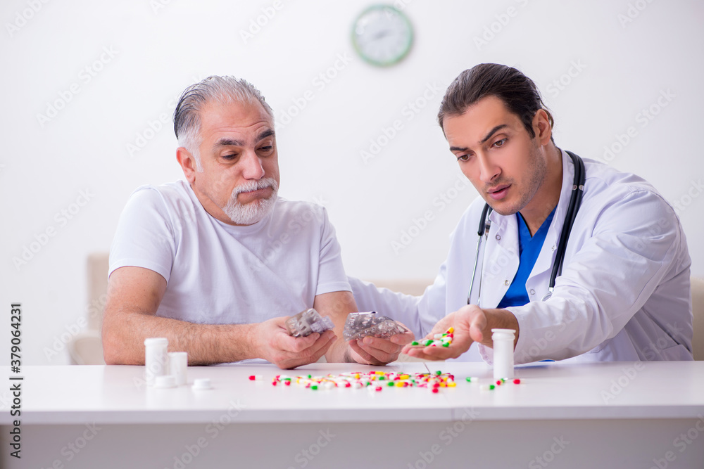 Young male doctor visiting old male patient at home Young male doctor visiting old male patient at home