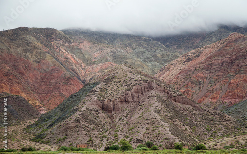 Mountain texture and colors. View of the colorful hills made of rock and minerals, under a cloudy sky. 