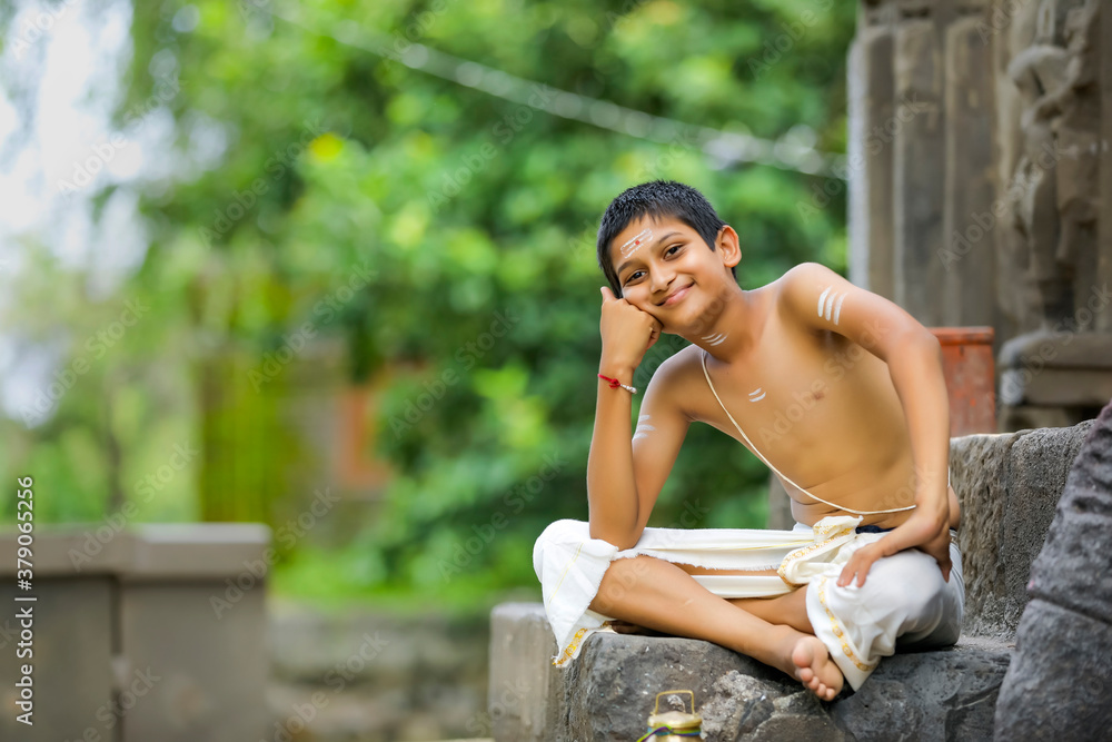 A indian priest child with holy water pot