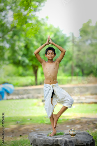 the indian priest child doing meditation © PRASANNAPIX