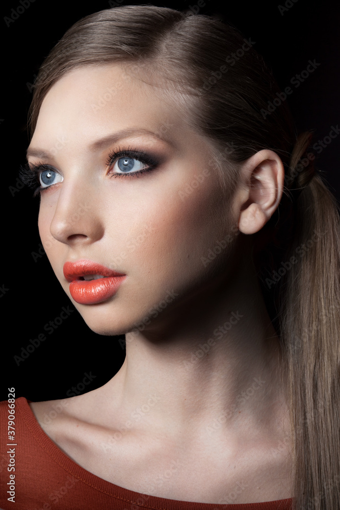 Closeup profile portrait of beautiful young woman with bright natural makeup, over black background. Closeup profile portrait of beautiful young woman with bright natural makeup, over black background.
