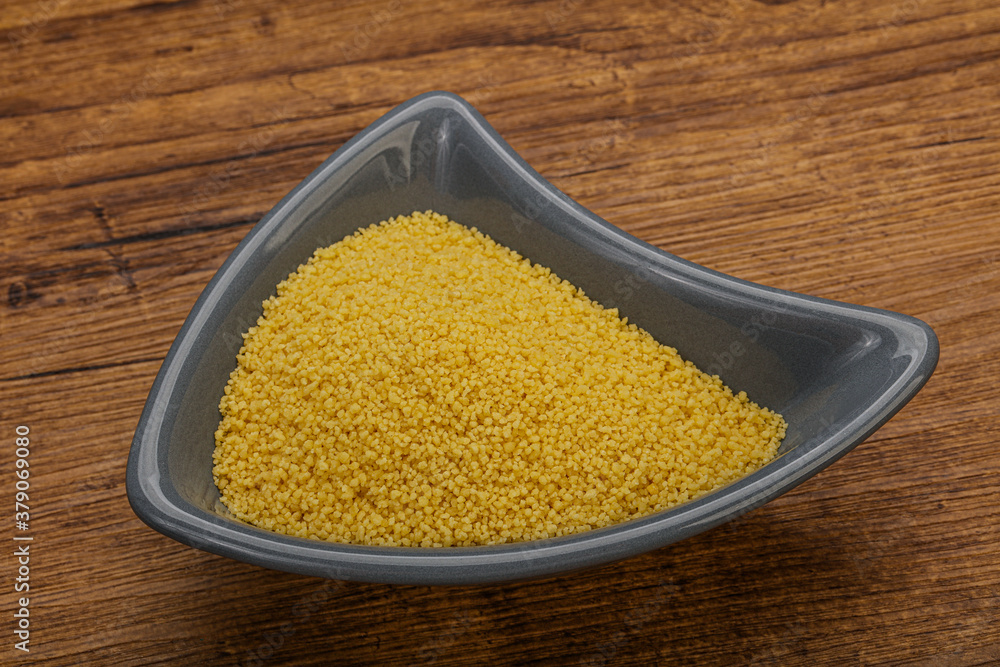 Raw cous cous heap in the bowl Raw cous cous heap in the bowl