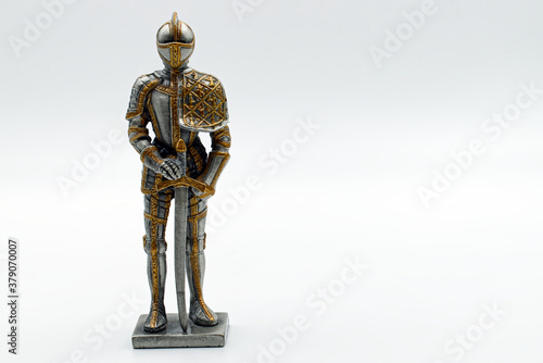 Medieval Knight in silver and gold armour with sword with board to write