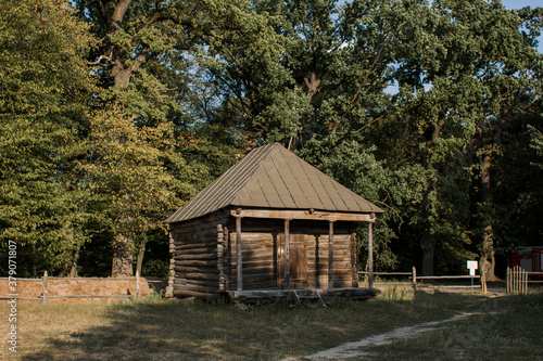 old wooden house with wooden roof in the village