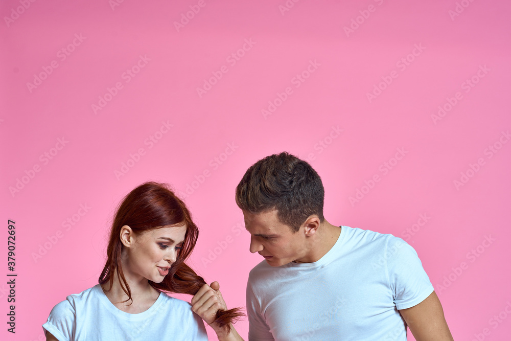 enamored man and woman hugging each other on a pink background cropped with Copy Space family portrait enamored man and woman hugging each other on a pink background cropped with Copy Space family portrait