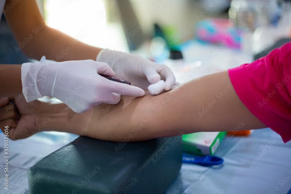 Close-up of nurse hands introducing the coronavirus vaccine introducing needle into vein of arm. Close-up of nurse hands introducing the coronavirus vaccine introducing needle into vein of arm.