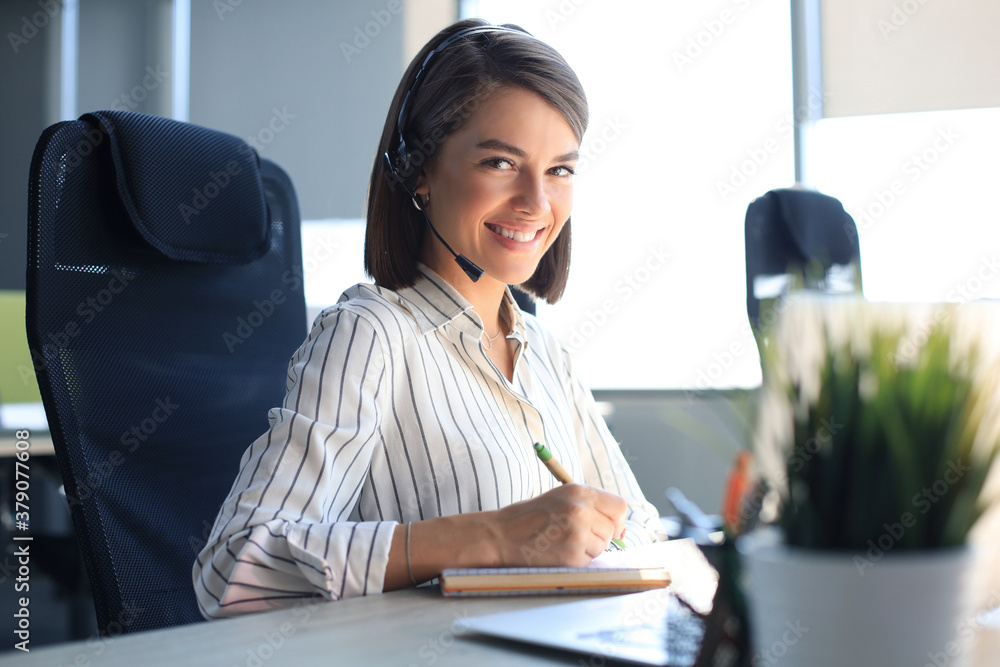 Female customer support operator with headset and smiling. Female customer support operator with headset and smiling.