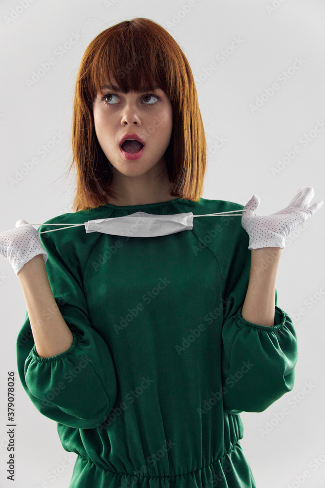 Woman in fashion dress posing in medical mask virus covid-19 Woman in fashion dress posing in medical mask virus covid-19