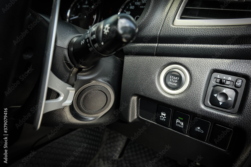 Fototapeta premium Close up engine car start button. Start stop engine modern new car button,Makes it easy to turn your auto mobile on and off. a key fob unique ,selective focus