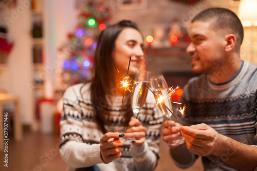 Loving couple with hand fireworks flicker brightly on christmas .