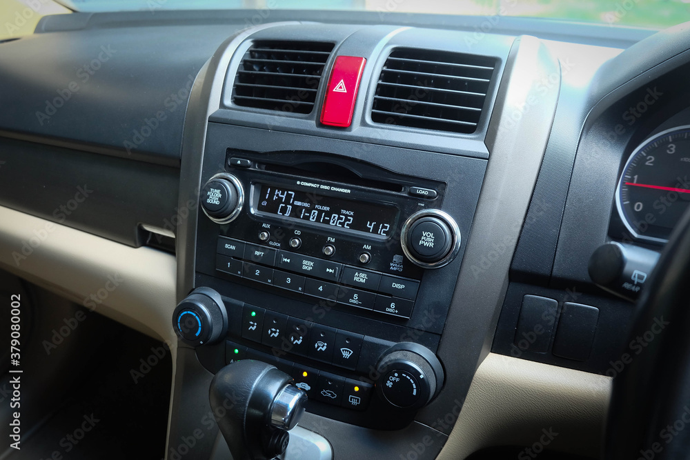 Close up image of car dashboard audio radio air conditioner console. Car audio player.