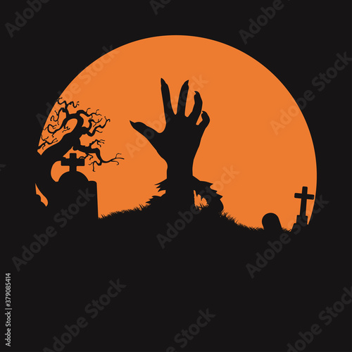 Hand rising out of a graveyard in the spooky night