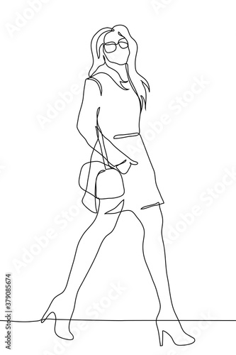 slender young woman in a short coat, sunglasses and high heels walks holding her hand with a bag in her pocket. A beautiful woman with long flowing hair walks with a wide stride looking at the observe