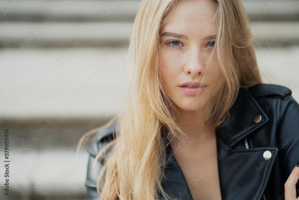 looking at the camera is a beautiful portrait of a young woman of European appearance. a determined confident lady in a black leather jacket looking at the camera is a beautiful portrait of a young woman of European appearance. a determined confident lady in a black leather jacket