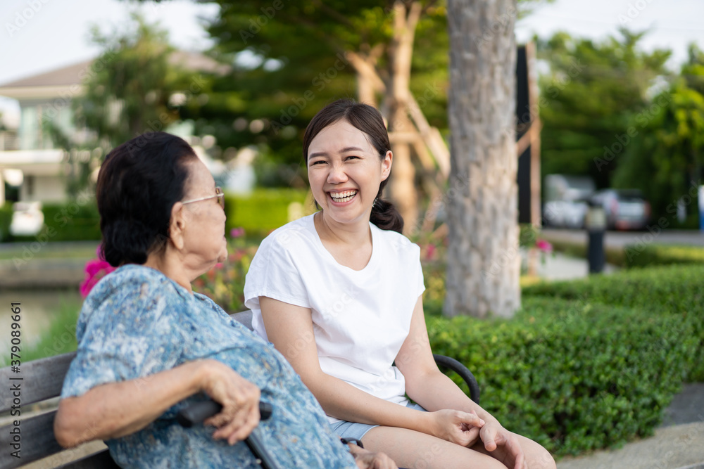 Grandma sitting beside her granddaughter in a park. Grandma sitting beside her granddaughter in a park.