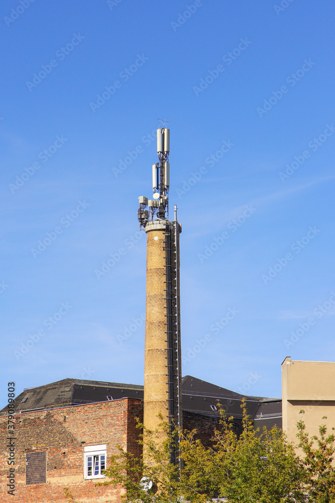 Old brick chimney with cell phone antennas.