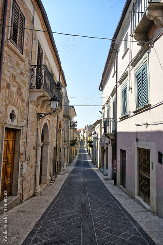 Fototapeta Naklejka Na Ścianę i Meble -  A narrow street among the old houses of San Bartolomeo in Galdo, a small town in the province of Benevento, Italy.
