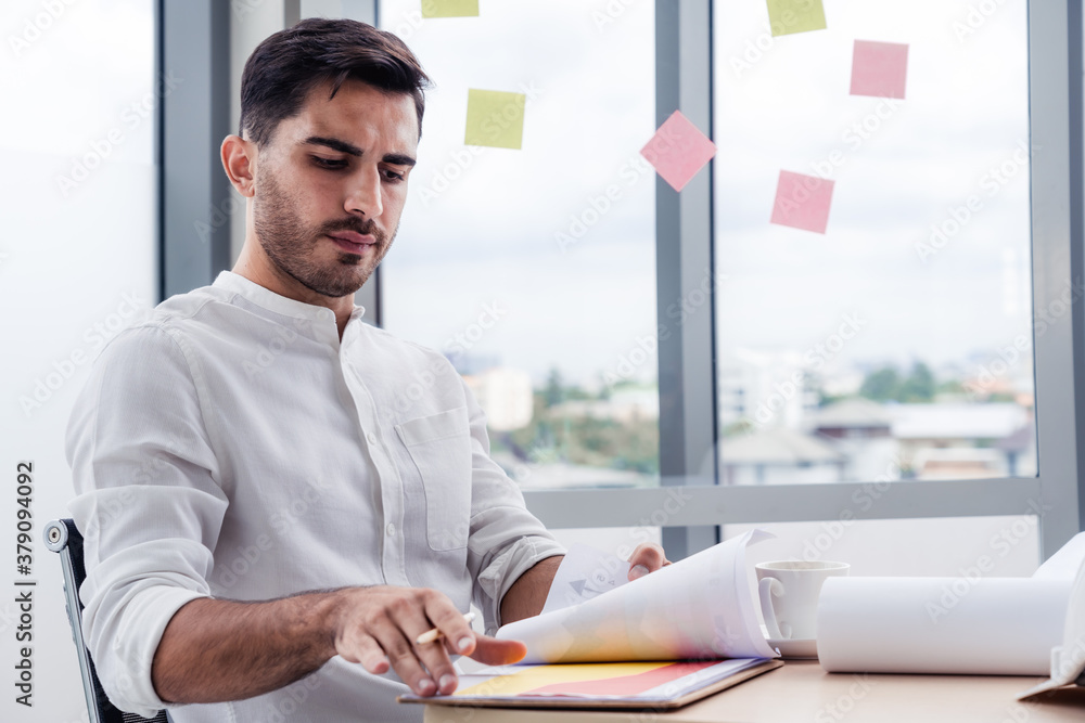 Handsome caucasian engineering man or architect working at workplace office or site, Serious concentrate working male Handsome caucasian engineering man or architect working at workplace office or site, Serious concentrate working male