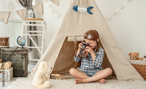 Pretty little girl playing in decorated room photo