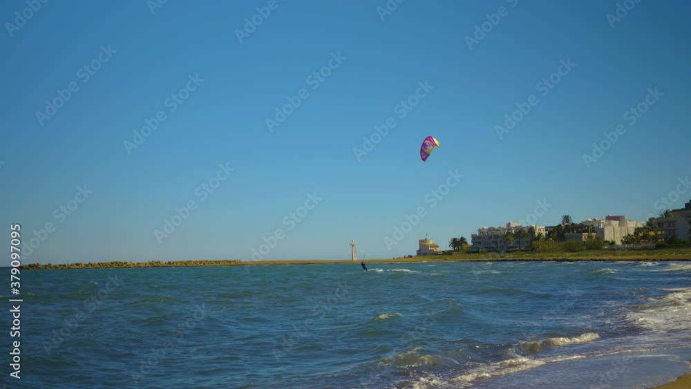 Kite surfers on the beach in Denia Spain on a sunny day in spring Kite surfers on the beach in Denia Spain on a sunny day in spring