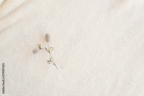 A soft cozy plaid made of white fabric with a pile lies in beautiful folds