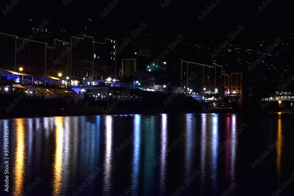 City of Camogli seen at night, with all its wonderful lights reflected in the sea