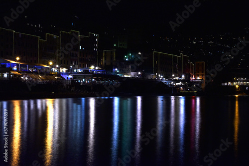 City of Camogli seen at night, with all its wonderful lights reflected in the sea