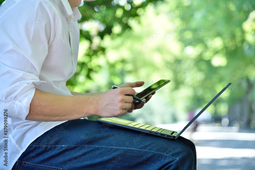 Financial auditor with laptop using smartphone Financial auditor with laptop using smartphone