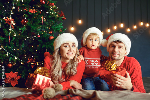 Happy family at home with christmas tree