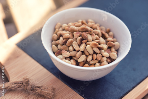 Grilled pine seeds in a bowl as a healthy delicious snack