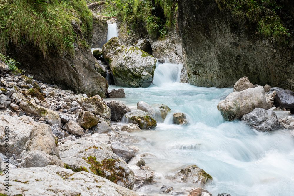Beautiful stream of water running through rocks and stones Beautiful stream of water running through rocks and stones