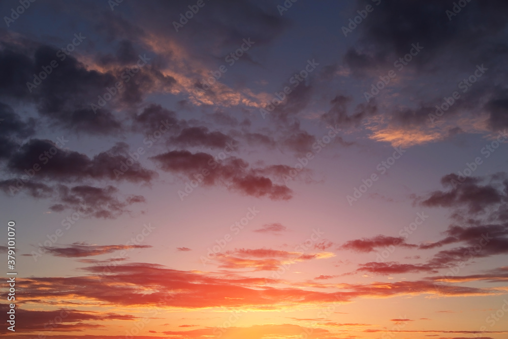 Beautiful sunrise, sunset orange yellow pink blue sky with clouds and sunlight background texture Beautiful sunrise, sunset orange yellow pink blue sky with clouds and sunlight background texture