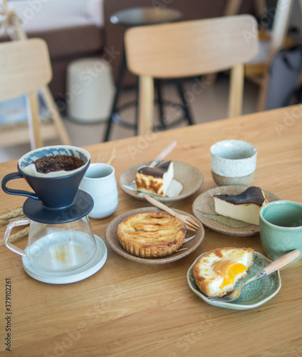 Set of sweet bakery in dishes ,Cone dripper on glass pot and ceramic cup.