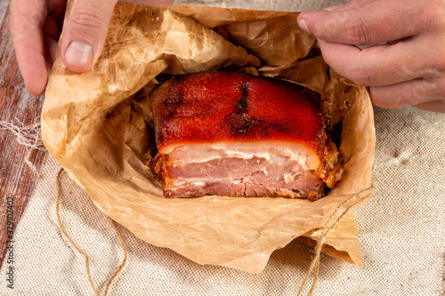 smoked meat wrapped in wrapping paper and tied with twine