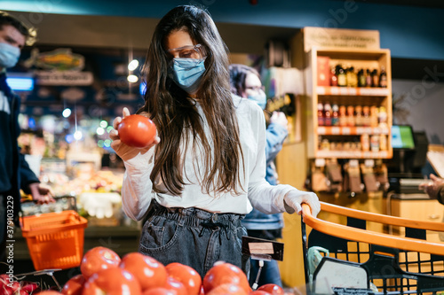 The girl with surgical mask is going to buy tomatos.