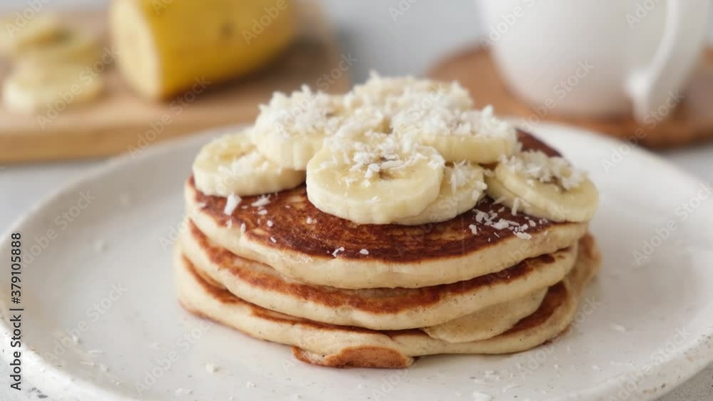 Pancakes with banana and coconut flakes. Decorating pancakes with coconut flakes Pancakes with banana and coconut flakes. Decorating pancakes with coconut flakes