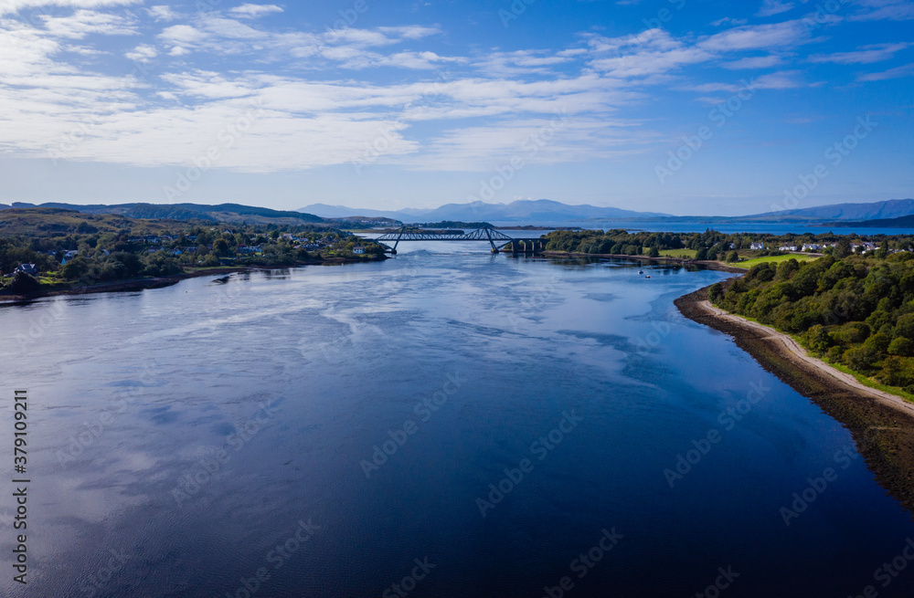 aerial view of the falls of lora near connel, connel bridge and oban in the argyll region of the highlands of scotland during a clear blue autumn day