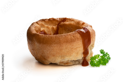 Yorkshire puddings with brown sauce isolated on white background