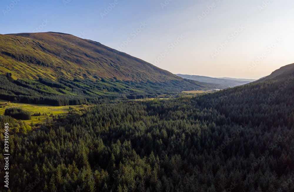 aerial view of glen orchy in the argyll region of the highlands of scotland during an autumn evening as the sun sets casting the glen into shadow