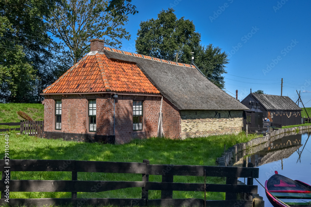 Old farmhouse with thatched roof in Enkhuizen.