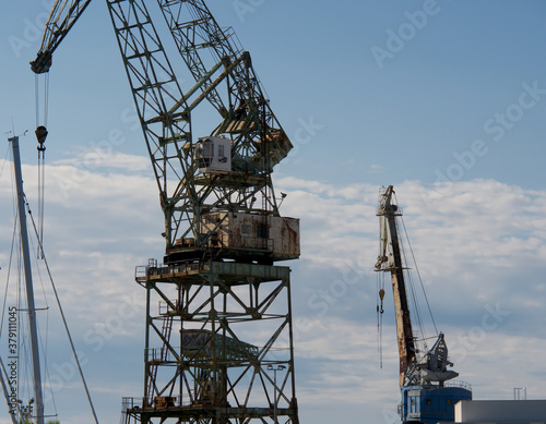 Wallpaper Mural  Port cranes for unloading and loading ship transport, Croatia port in the city of Trogir Torontodigital.ca