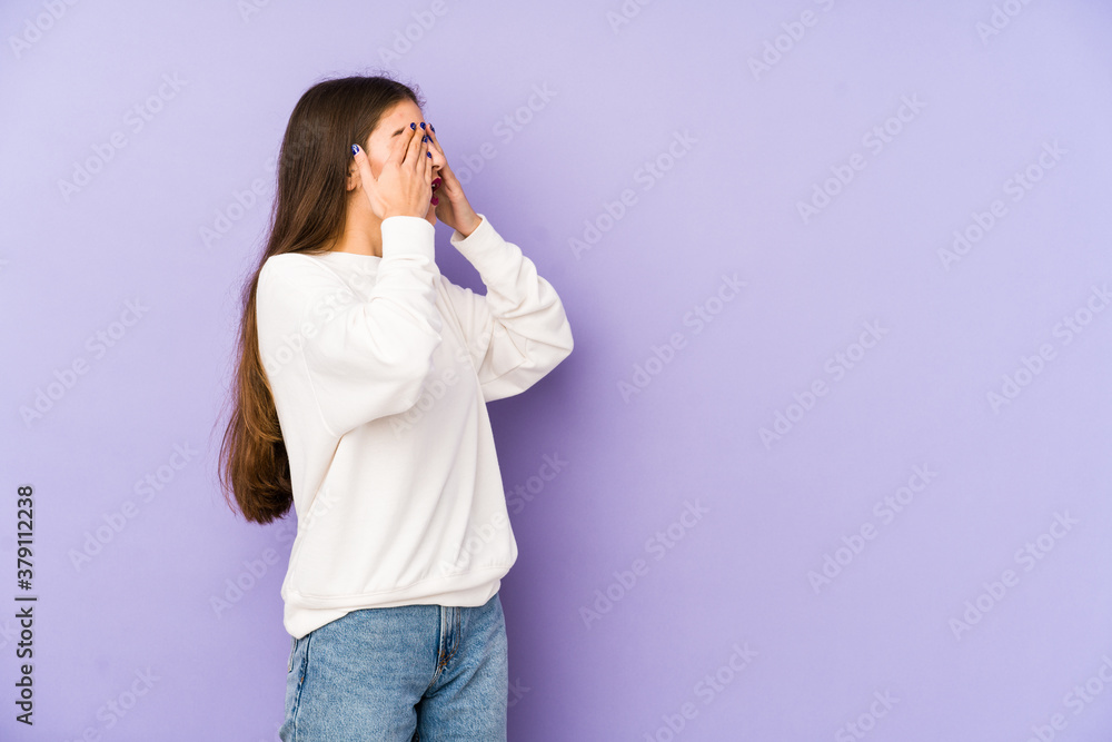 Young caucasian woman isolated on purple background afraid covering eyes with hands. Young caucasian woman isolated on purple background afraid covering eyes with hands.