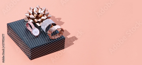 Fashion scene jewelry watches and bracelets in isometric with gift box.  Copy space. .Gift, date, shopping, online shopping, sale concept photo