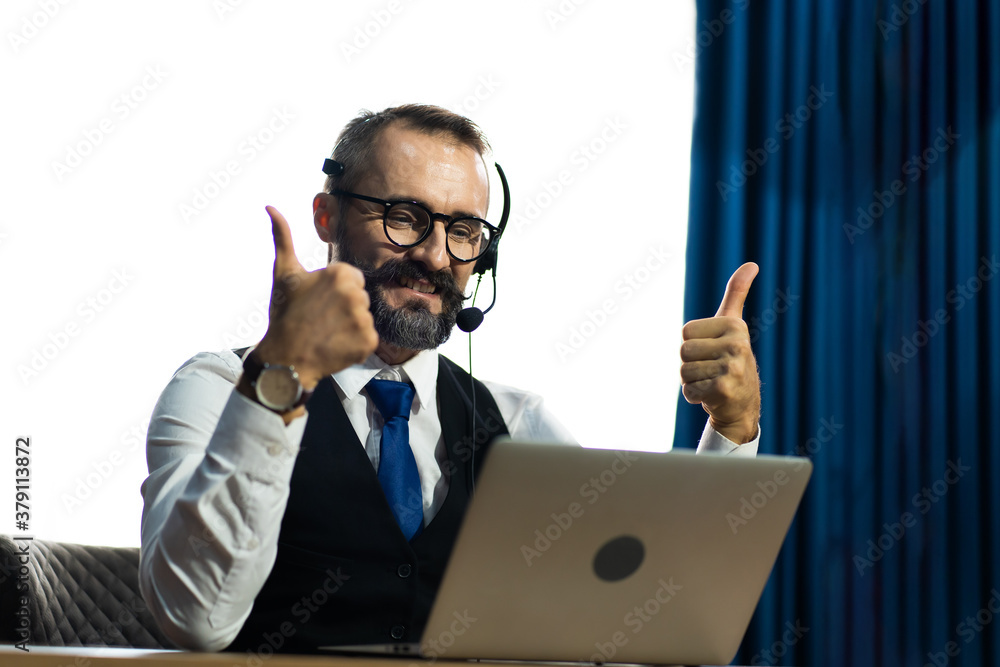 Tele marketing sale support operator with hands-free headset working in the office. Customer service. Online learning and video conference concept Tele marketing sale support operator with hands-free headset working in the office. Customer service. Online learning and video conference concept
