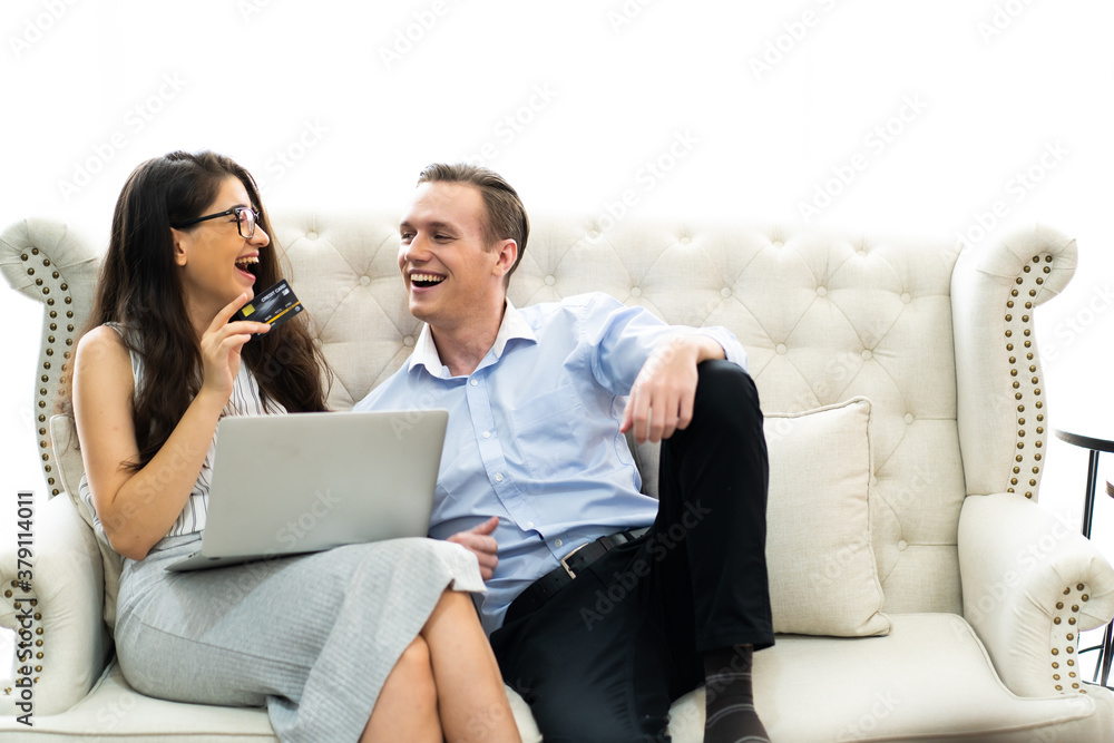 Young caucasian couple using laptop computer at home..shopping online at home. couple planning a trip abroad on their wedding anniversary Young caucasian couple using laptop computer at home..shopping online at home. couple planning a trip abroad on their wedding anniversary