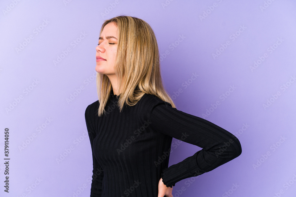 Young blonde caucasian woman isolated suffering a back pain. Young blonde caucasian woman isolated suffering a back pain.