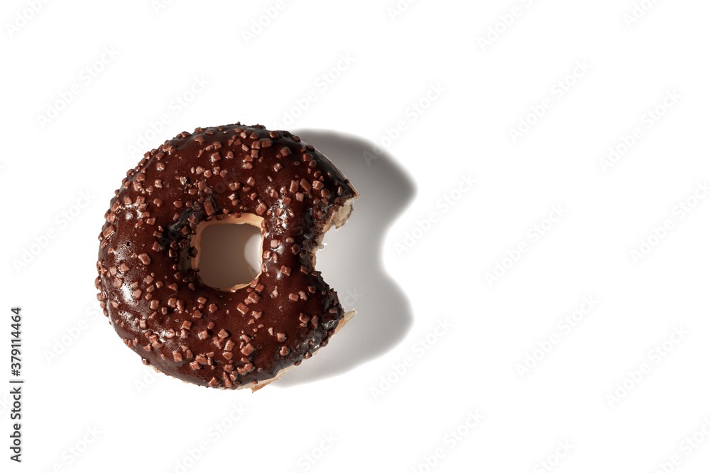 Close up view of bitten chocolate donut on white background isolated. Food and health concept. Close up view of bitten chocolate donut on white background isolated. Food and health concept.