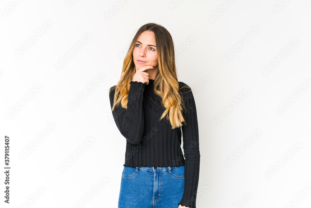 Young caucasian woman isolated on white background looking sideways with doubtful and skeptical expression. Young caucasian woman isolated on white background looking sideways with doubtful and skeptical expression.